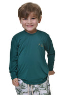 Camiseta de proteção UV infantil verde petróleo manga longa com logo dourado, usada por menino em fundo branco